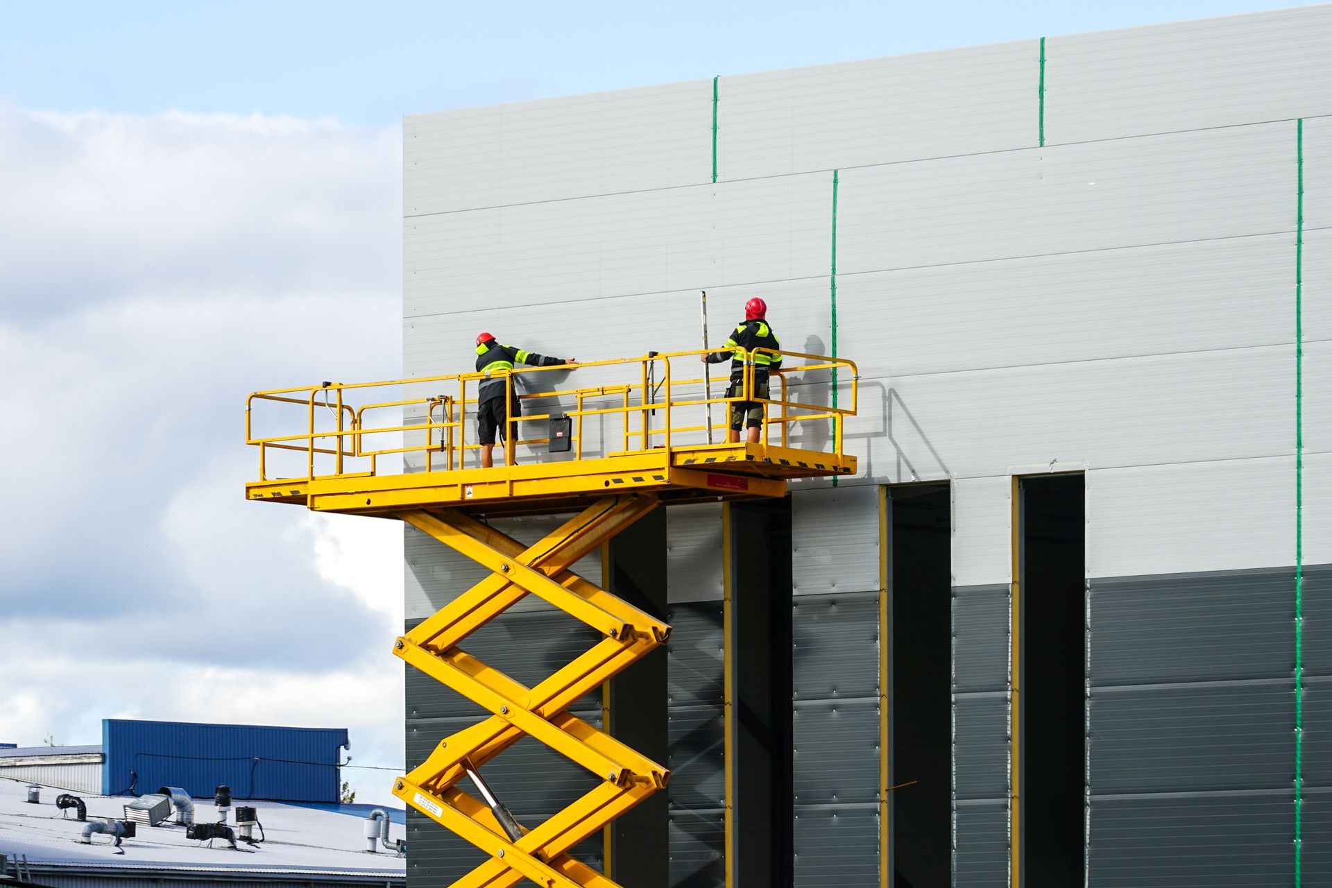 Man operating a forklift, carrying a pallet with a large cardboard box inside a warehouse. Man operating a forklift, carrying a pallet with a large cardboard box inside a warehouse.