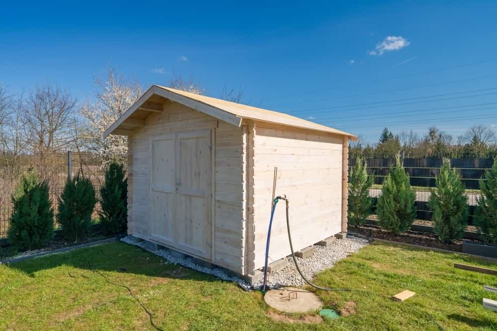 Wooden Shed in a Grassy Yard, With Blue Sky and Trees in the Background — ShedBoss in Millaa Millaa, QLD 