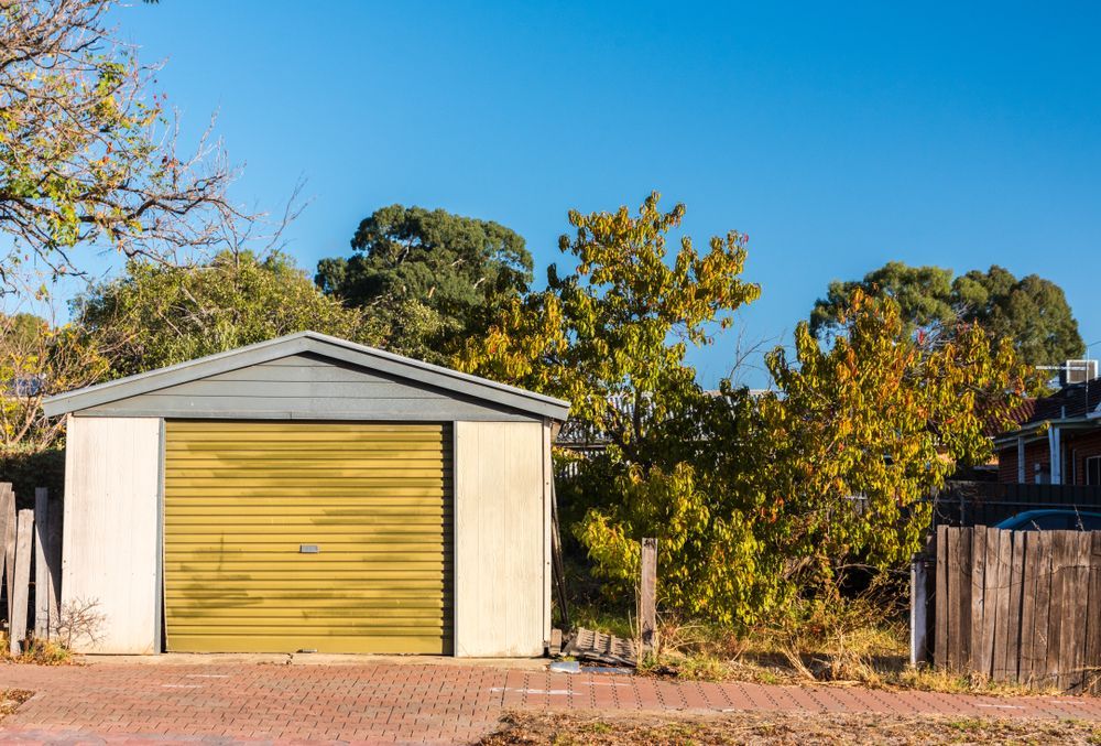 Garage With Yellow Door, on a Brick Driveway — ShedBoss in Atherton, QLD