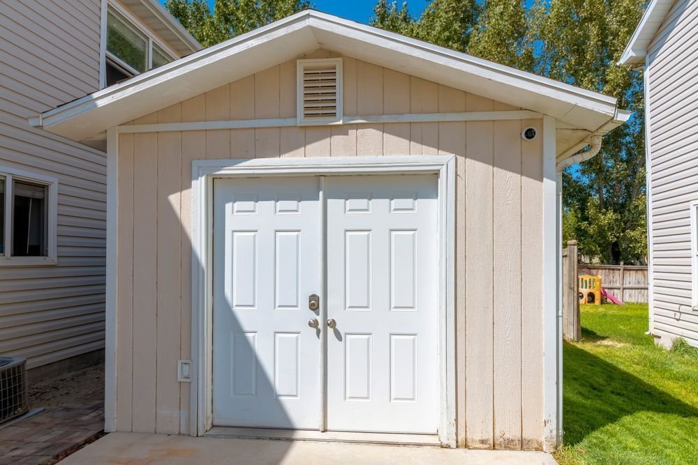 Beige Shed With Double Doors, White Trim, and a Small Vent — ShedBoss in Yungaburra, QLD