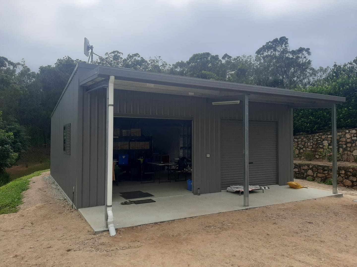 Gray Metal Garage With a Covered Carport — ShedBoss in Atherton, QLD