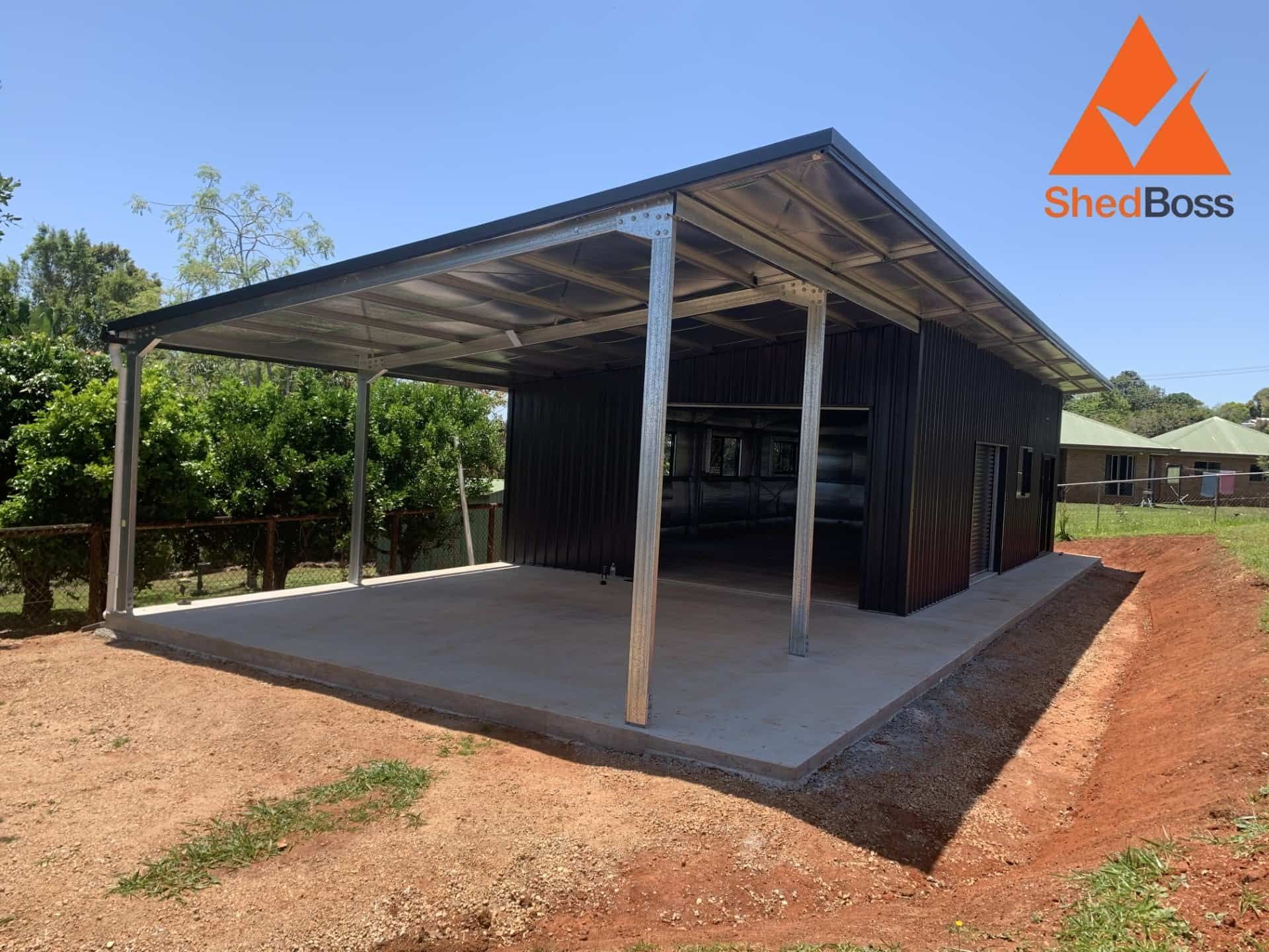 Black Metal Shed With Carport on a Concrete Pad — ShedBoss in Atherton, QLD