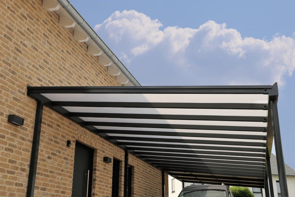 A Modern Black and White Patio Cover Attached to a Brick Building — ShedBoss in Yungaburra, QLD 