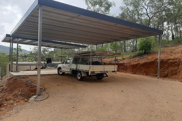 Truck Parked Under a Carport With a Grey Roof — ShedBoss in Atherton, QLD