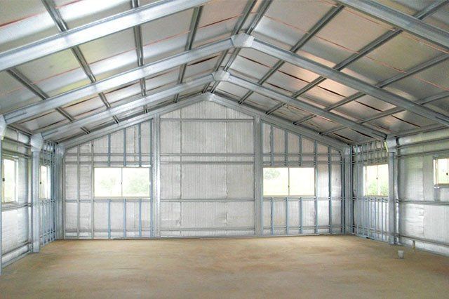 Interior of a Metal Framed Building With a Sloped Ceiling and Windows — ShedBoss in Atherton, QLD