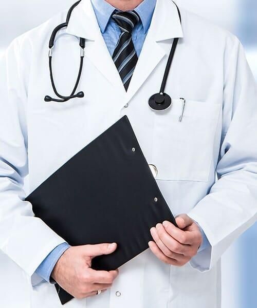 Un médico con un estetoscopio alrededor del cuello sostiene una carpeta negra