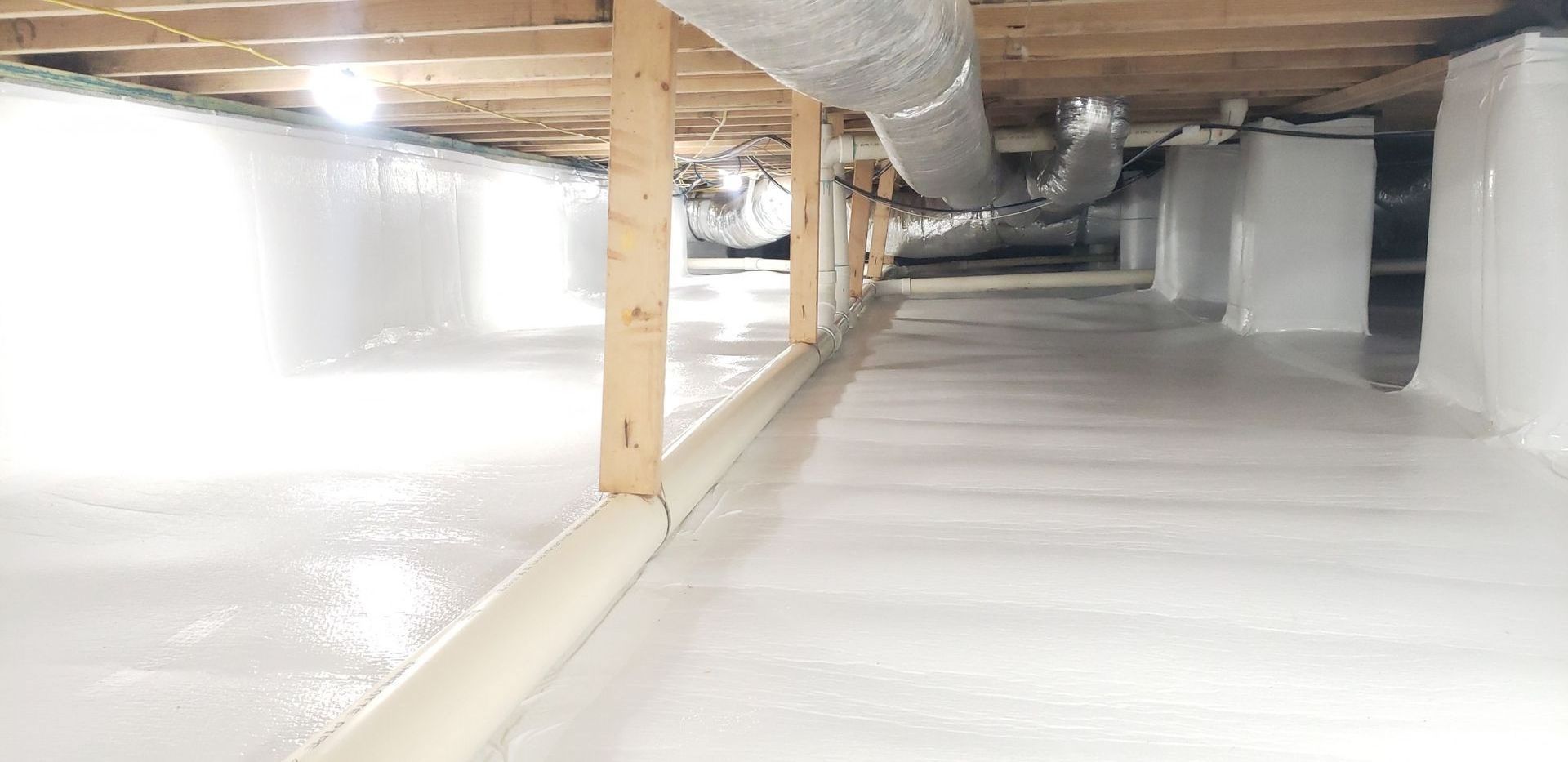 There is a pipe in the ceiling of a room.