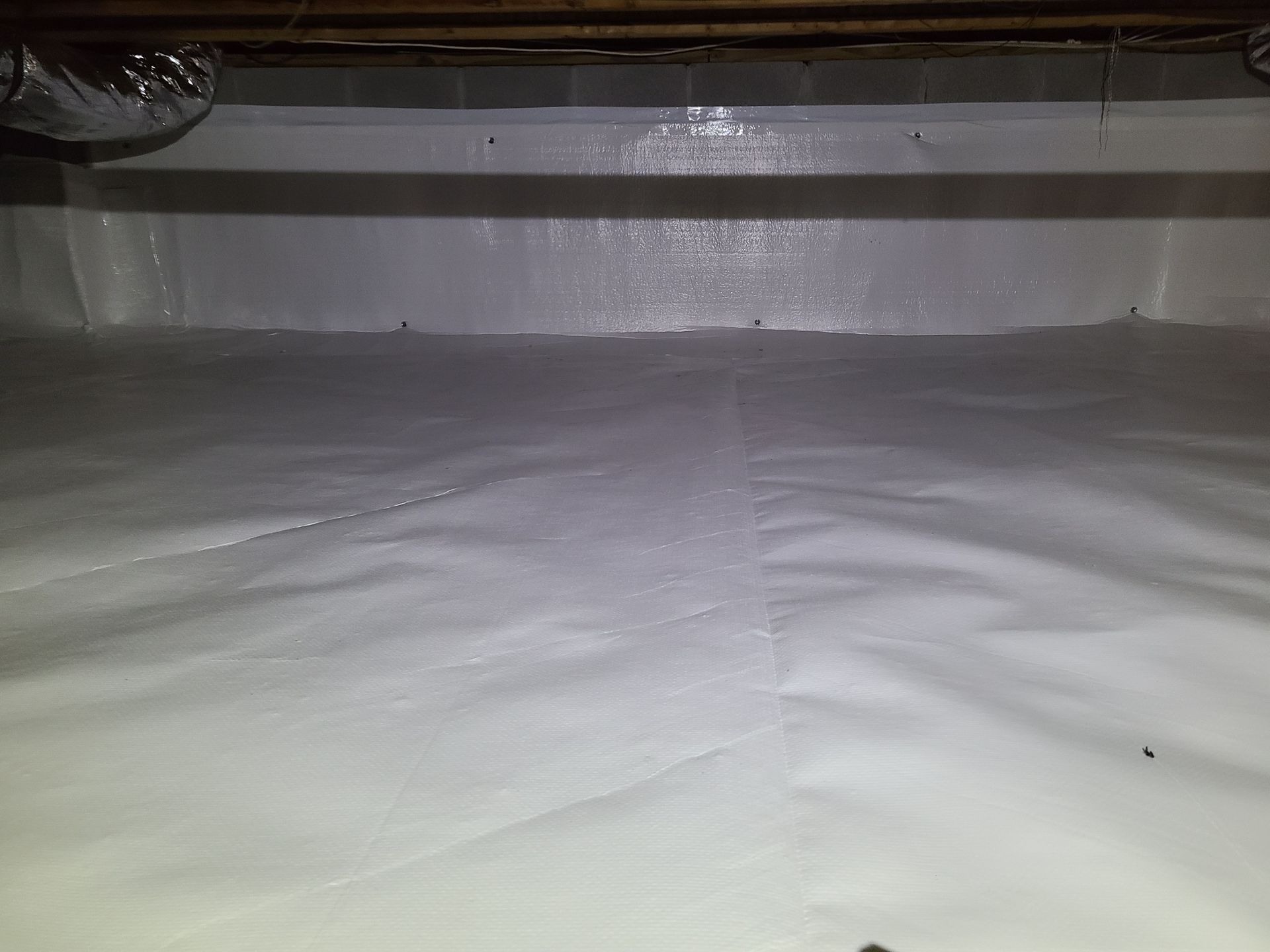 A white tarp is covering the ceiling of a room.