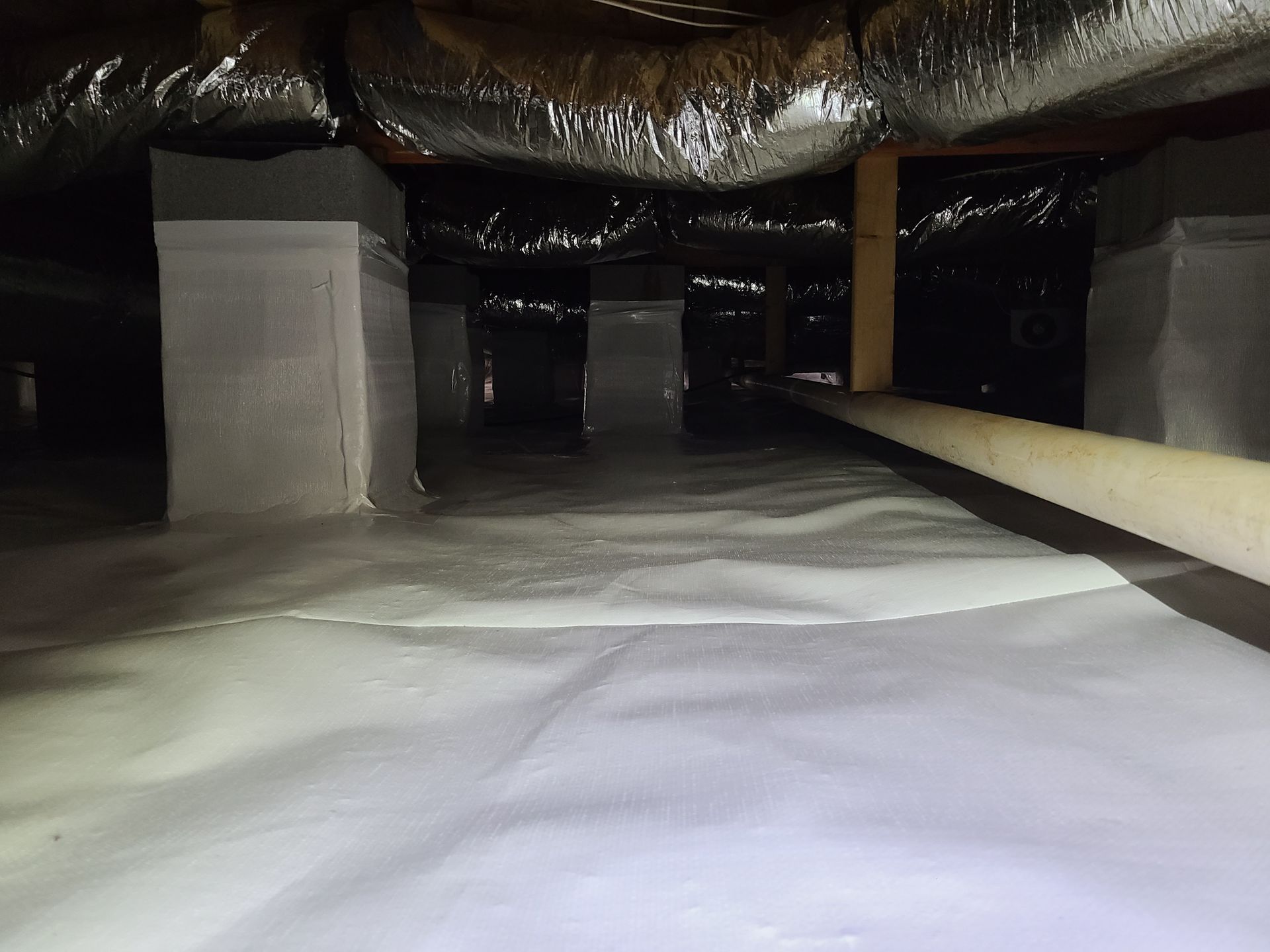A room with a lot of ducts and a white ceiling.