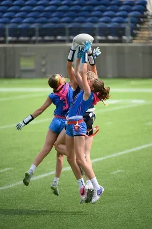 Girls, catching football | T3 Turf Legends Flag Football.