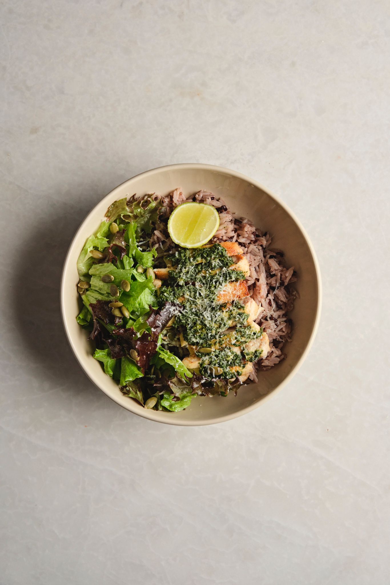 <b>grilled chicken bowl w/ pesto</b><br>basmati pilaf, green salad, parmesan (520 gr.)<br>940 kcal