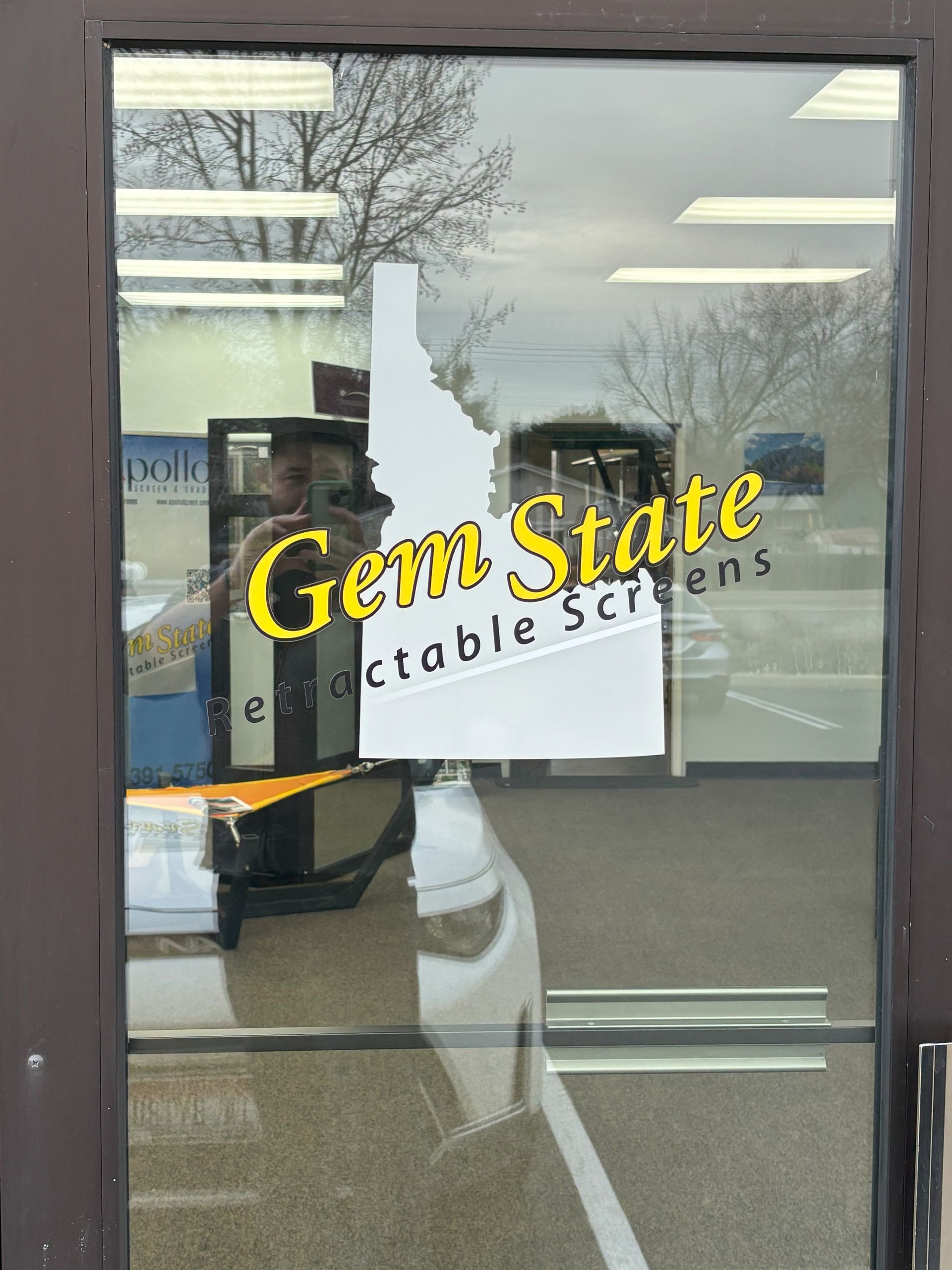 A glass door that says gem state on it