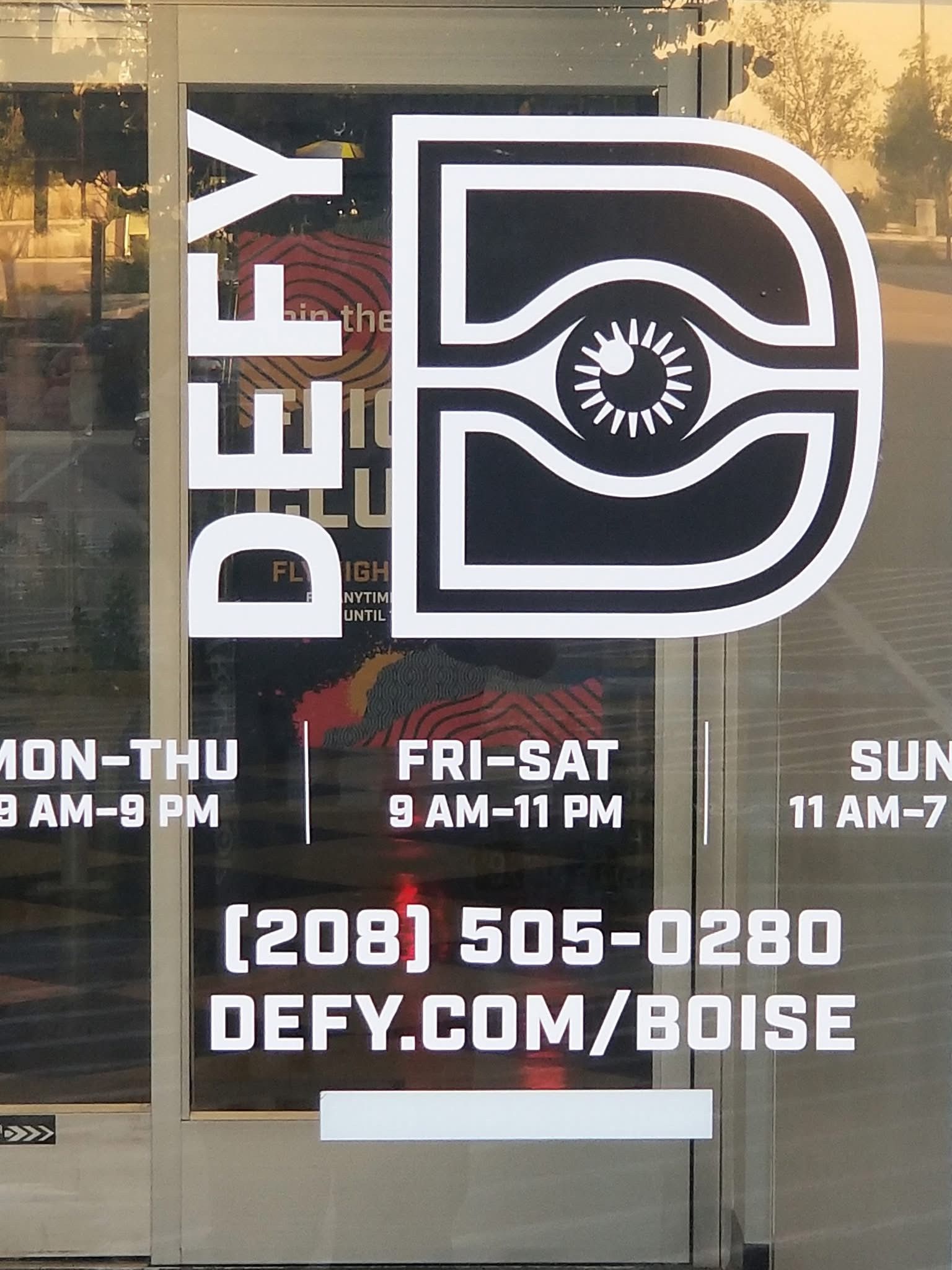 A sign on a door that says defy on it