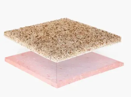 A piece of granite is sitting on top of a piece of pink granite.