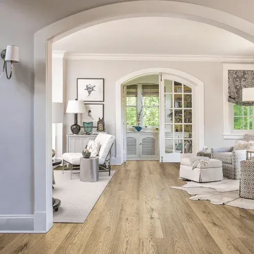 A living room with hardwood floors and white walls.
