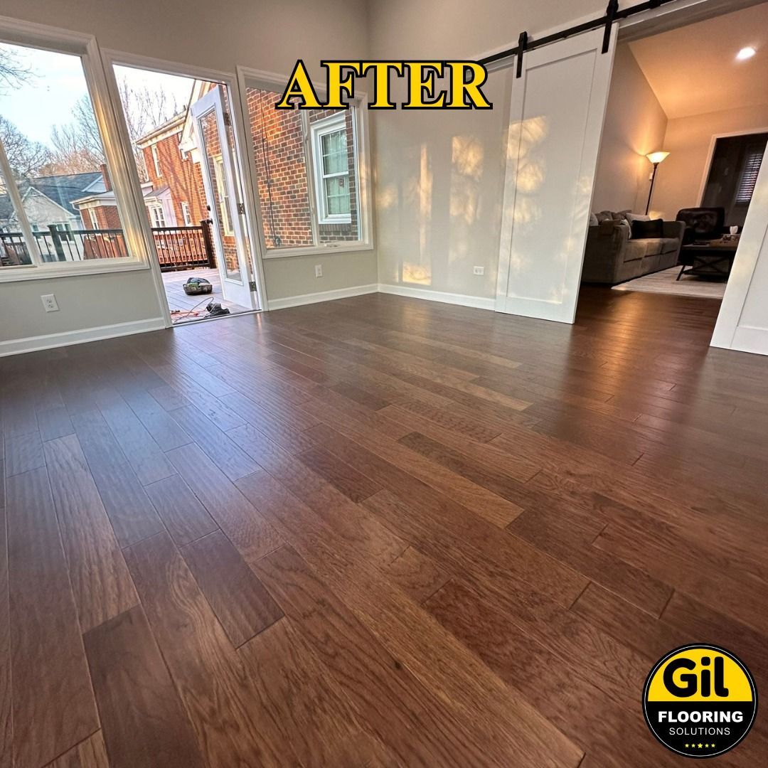 A living room with hardwood floors and a sliding barn door.