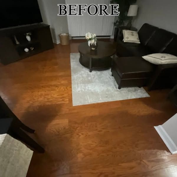 A before picture of a living room with hardwood floors