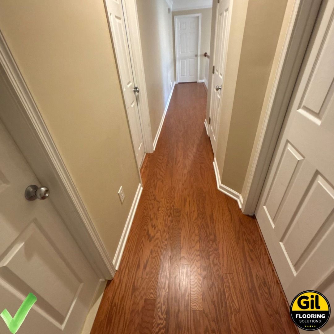 A hallway with hardwood floors and white doors A hallway with hardwood floors and white doors