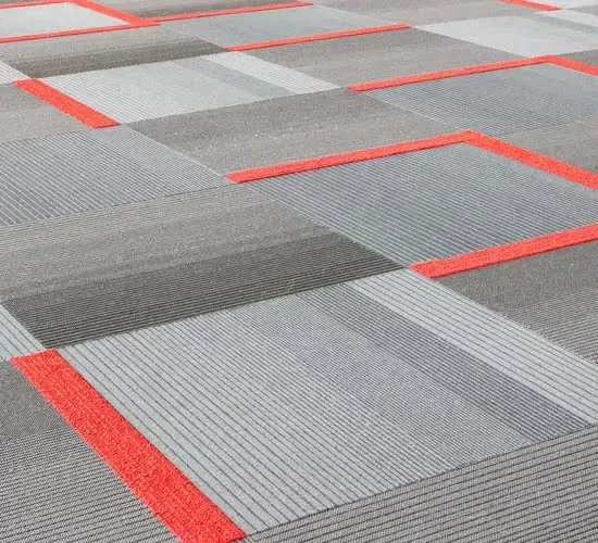 A close up of a carpet with red stripes on it.