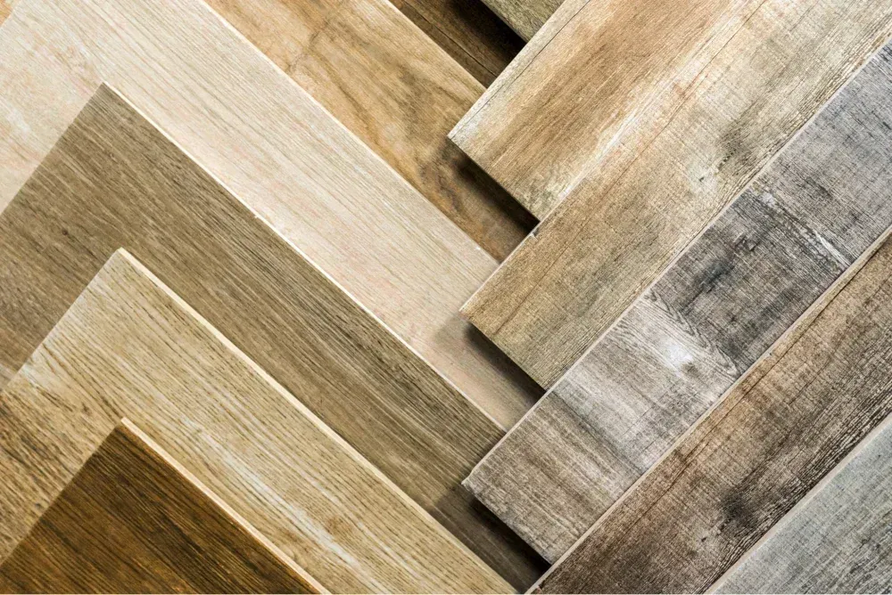 A close up of a variety of wooden floor tiles stacked on top of each other.