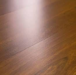 A close up of a wooden floor with a light shining on it.