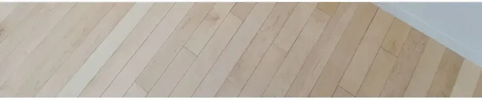 A close up of a wooden floor with a white border. A close up of a wooden floor with a white border.