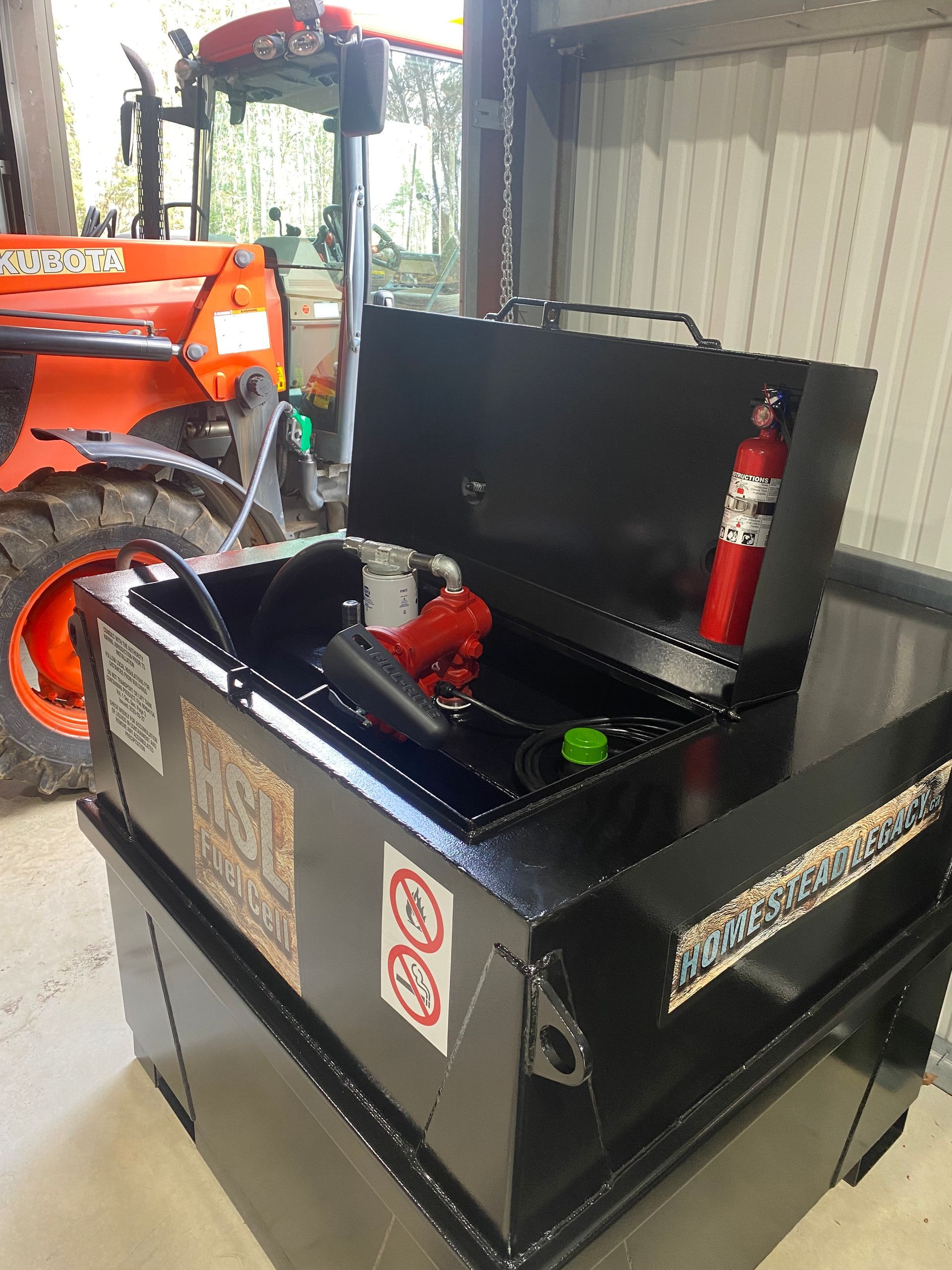 A tractor is parked behind a black box with the lid open.