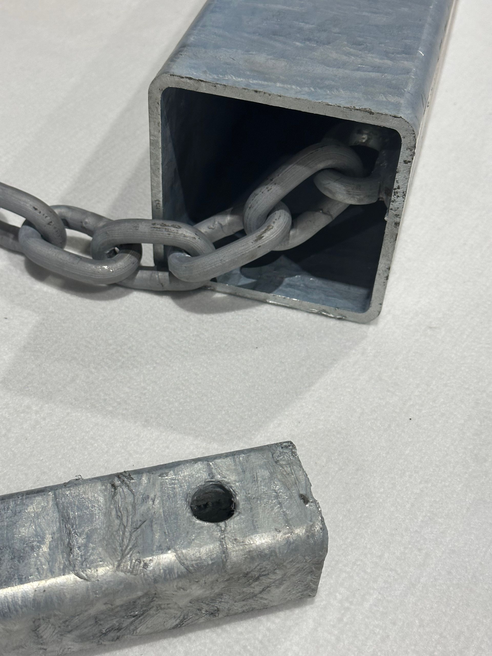 A piece of metal with a chain attached to it