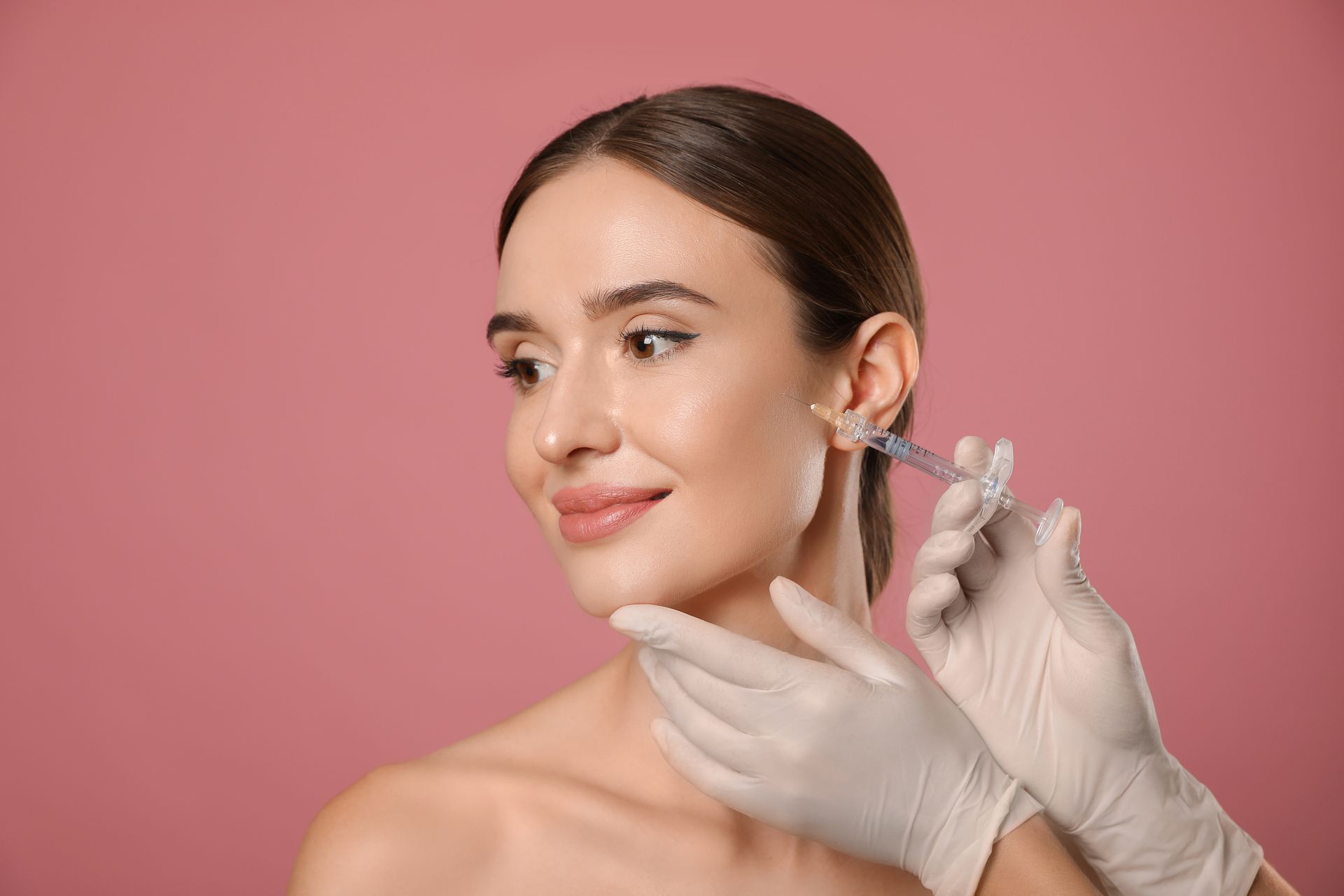 A woman is getting a botox injection in her face.