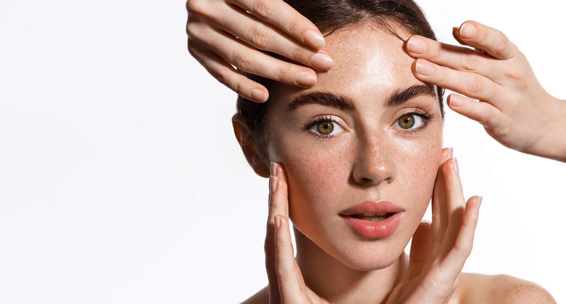 A woman headshot touching her face
