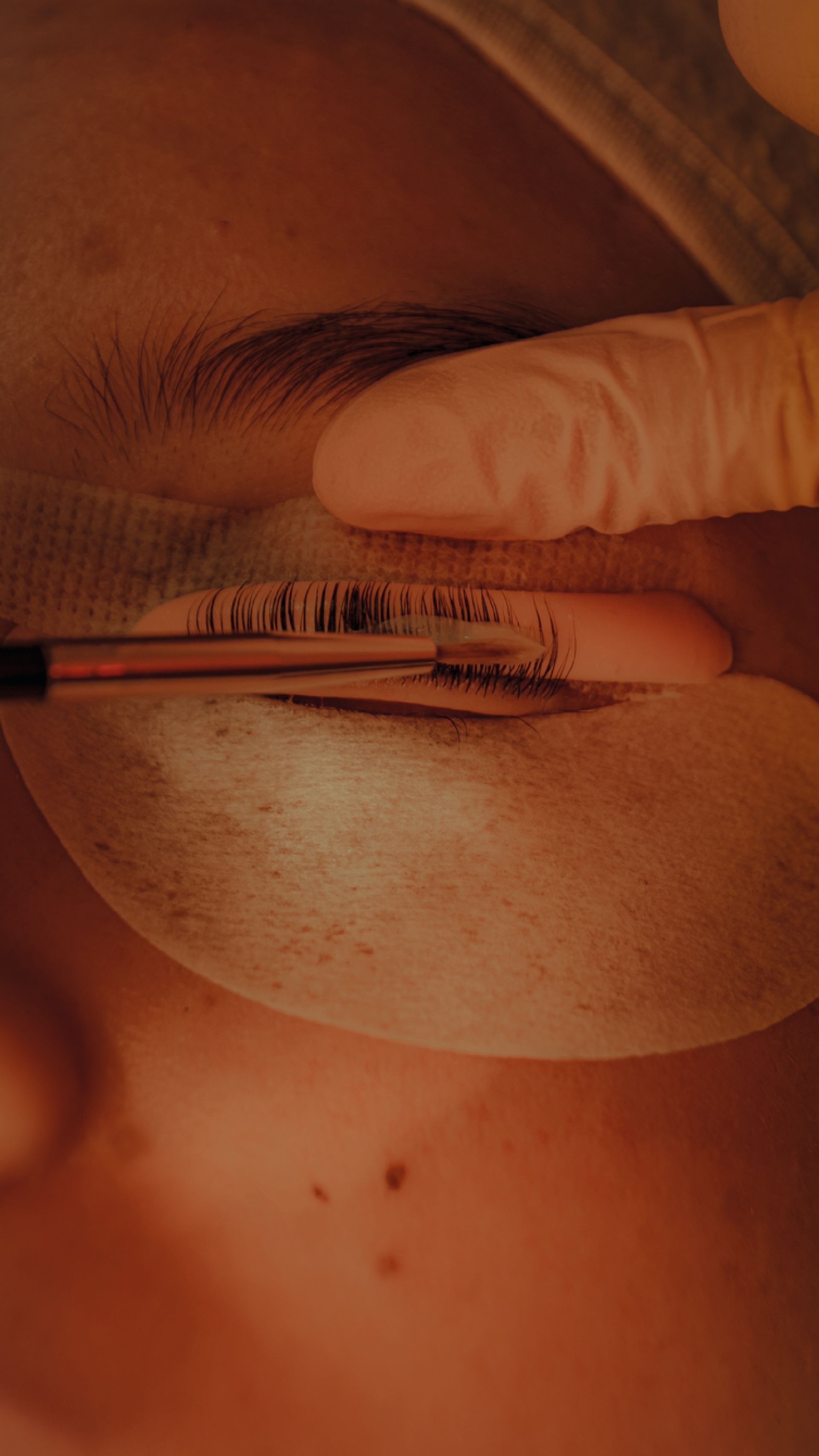 A close up of a person 's eye with a brush on it.
