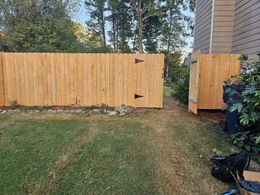 Wooden horizontal slat privacy fence.