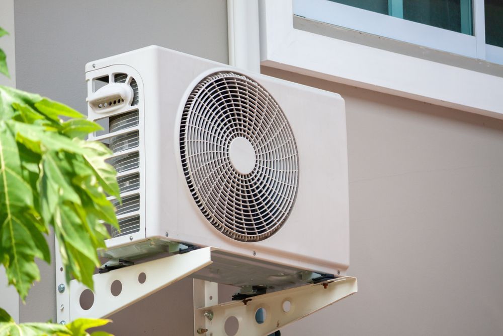 White Air Conditioner Unit Mounted on a Wall — Refrigeration & Air Supplies (South Coast) In Shellharbour, NSW