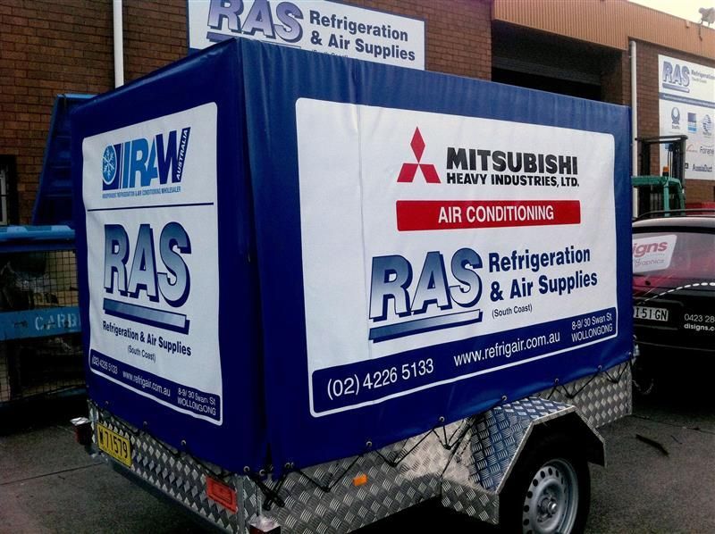 Blue trailer with company logos: