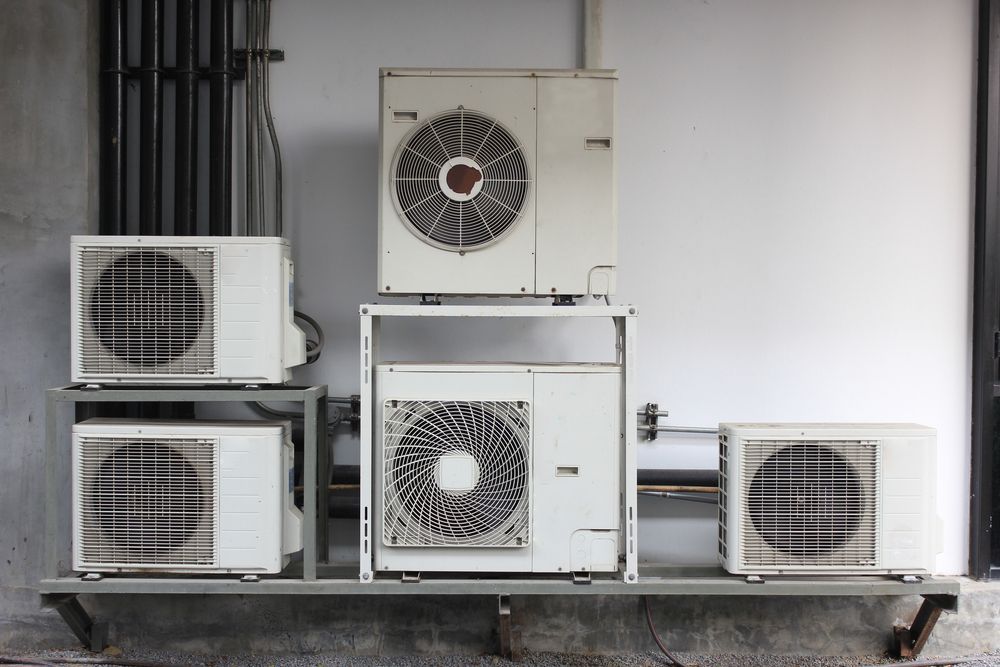 Five White Air Conditioning Units Mounted on a Gray Platform — Refrigeration & Air Supplies (South Coast) In Jervis Bay, NSW