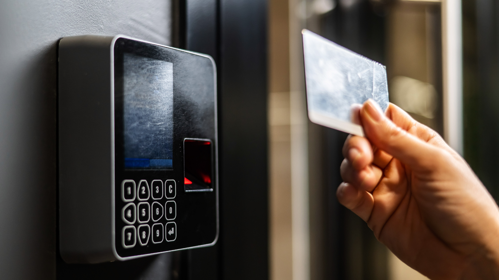 A person is using a key card to access a door.