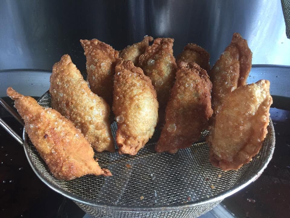 Fried pastries cooling on a wire rack, golden brown and crispy