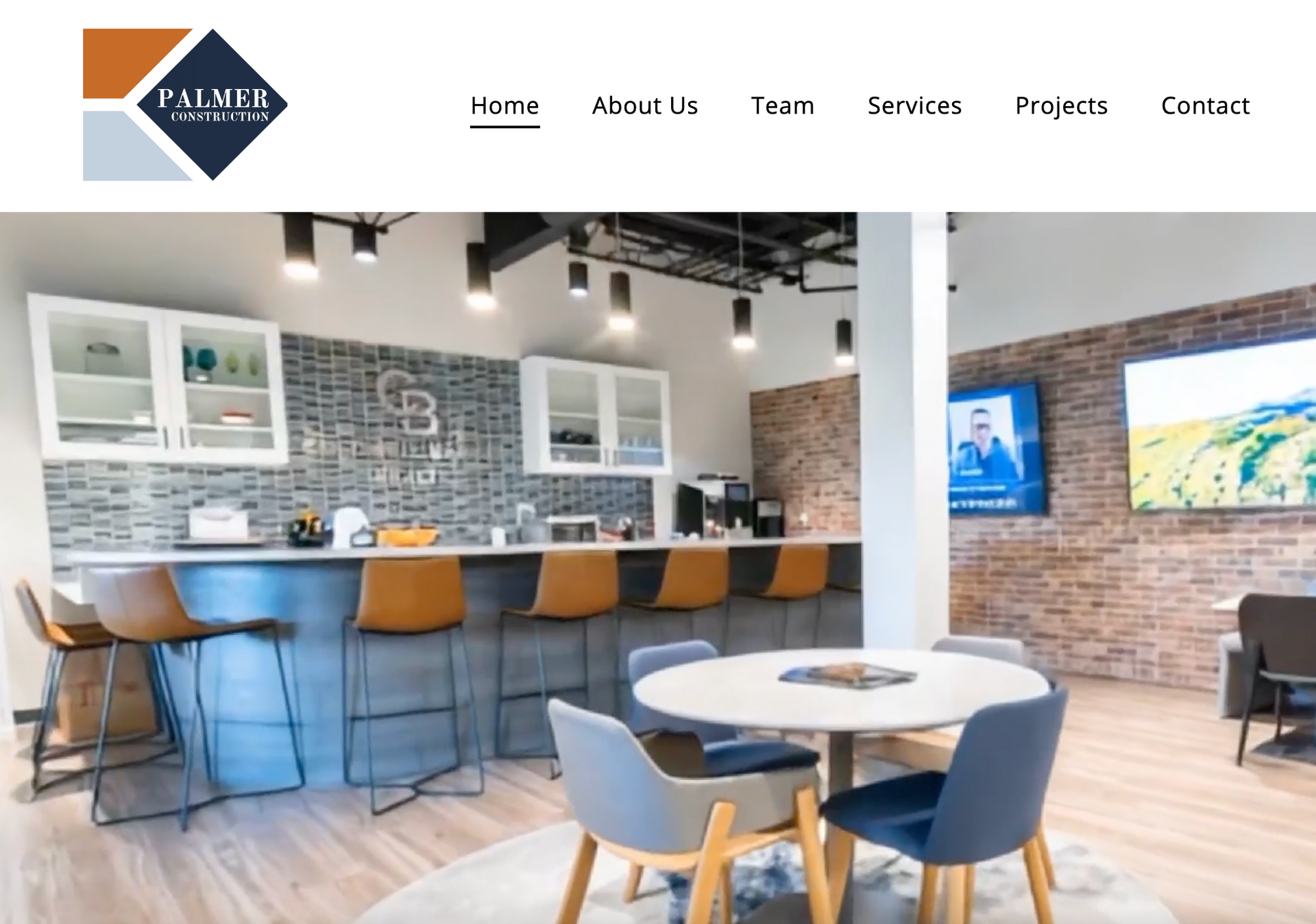 Modern café interior with blue chairs, round tables, and a long counter with bar stools