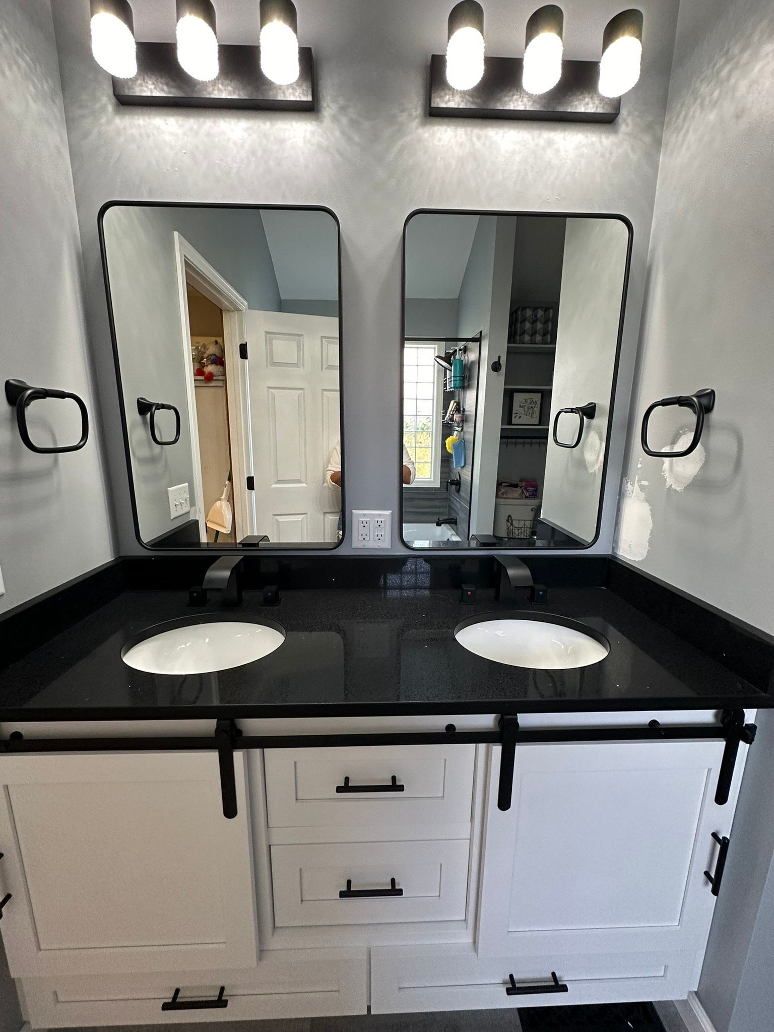 A bathroom with two sinks and two mirrors.