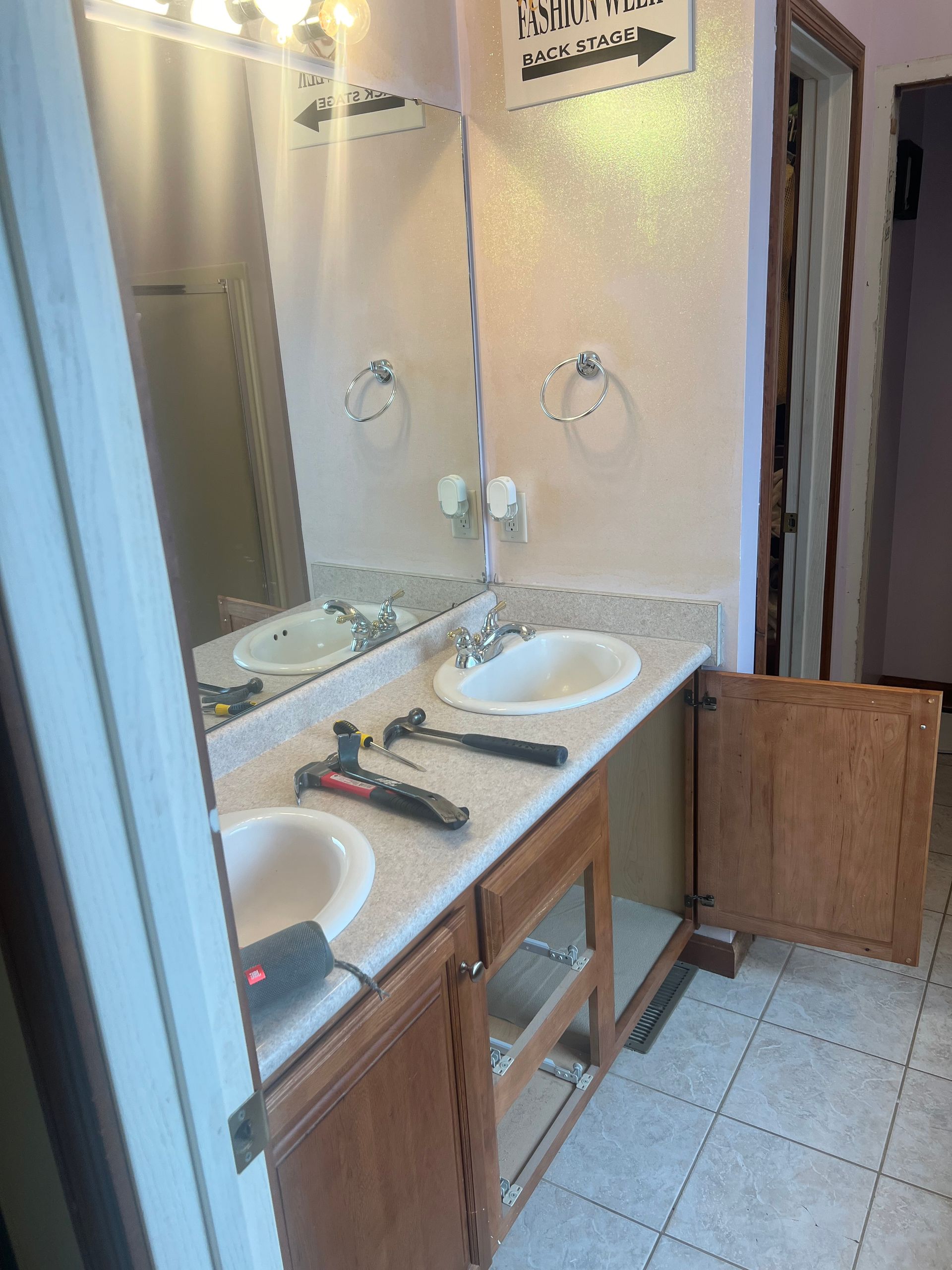 A bathroom with two sinks and a mirror.