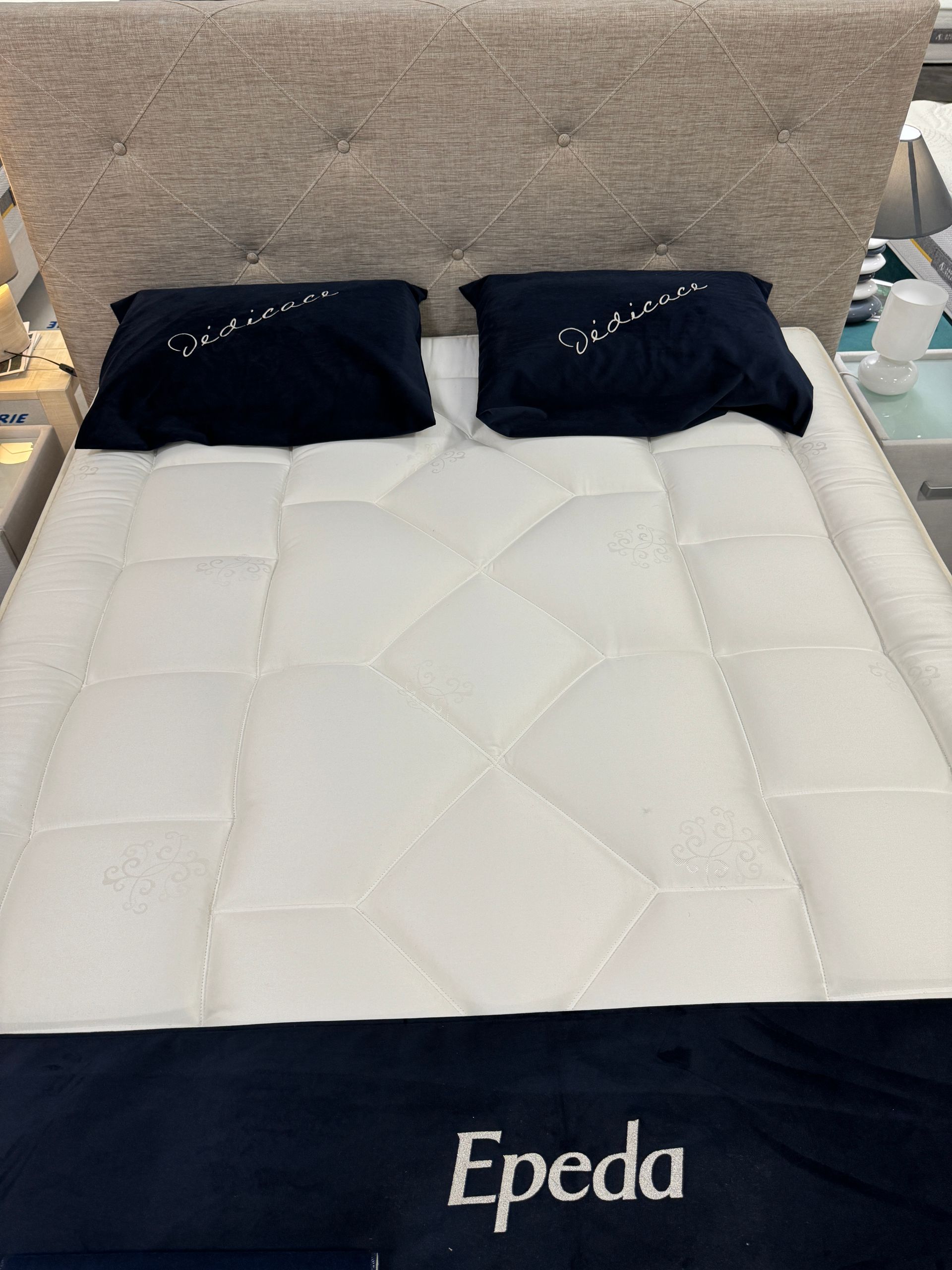 A bed with a mattress and pillows from epeda