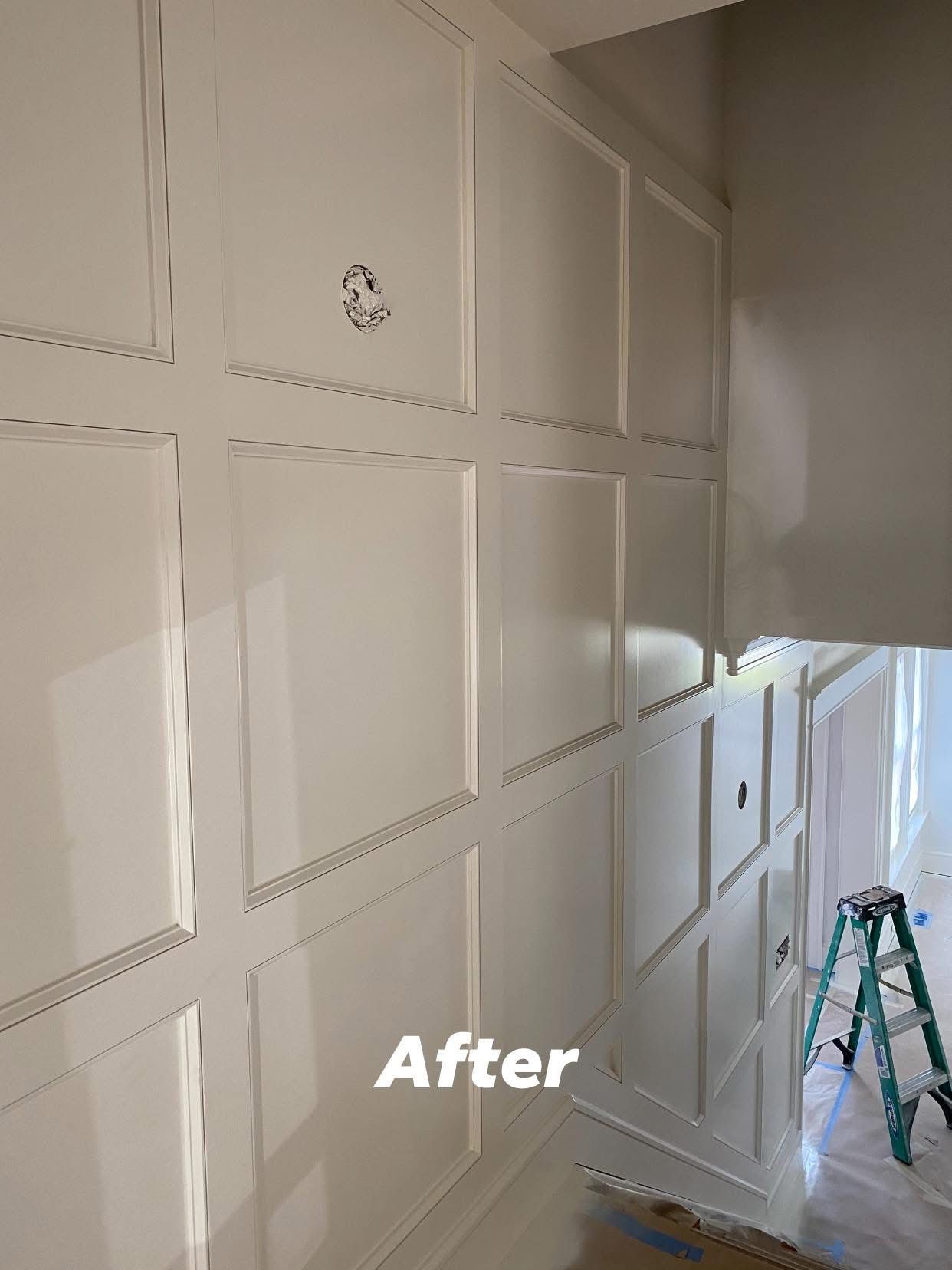 Freshly painted white wall with decorative panel molding in a hallway, labeled “After,” with a ladder nearby.