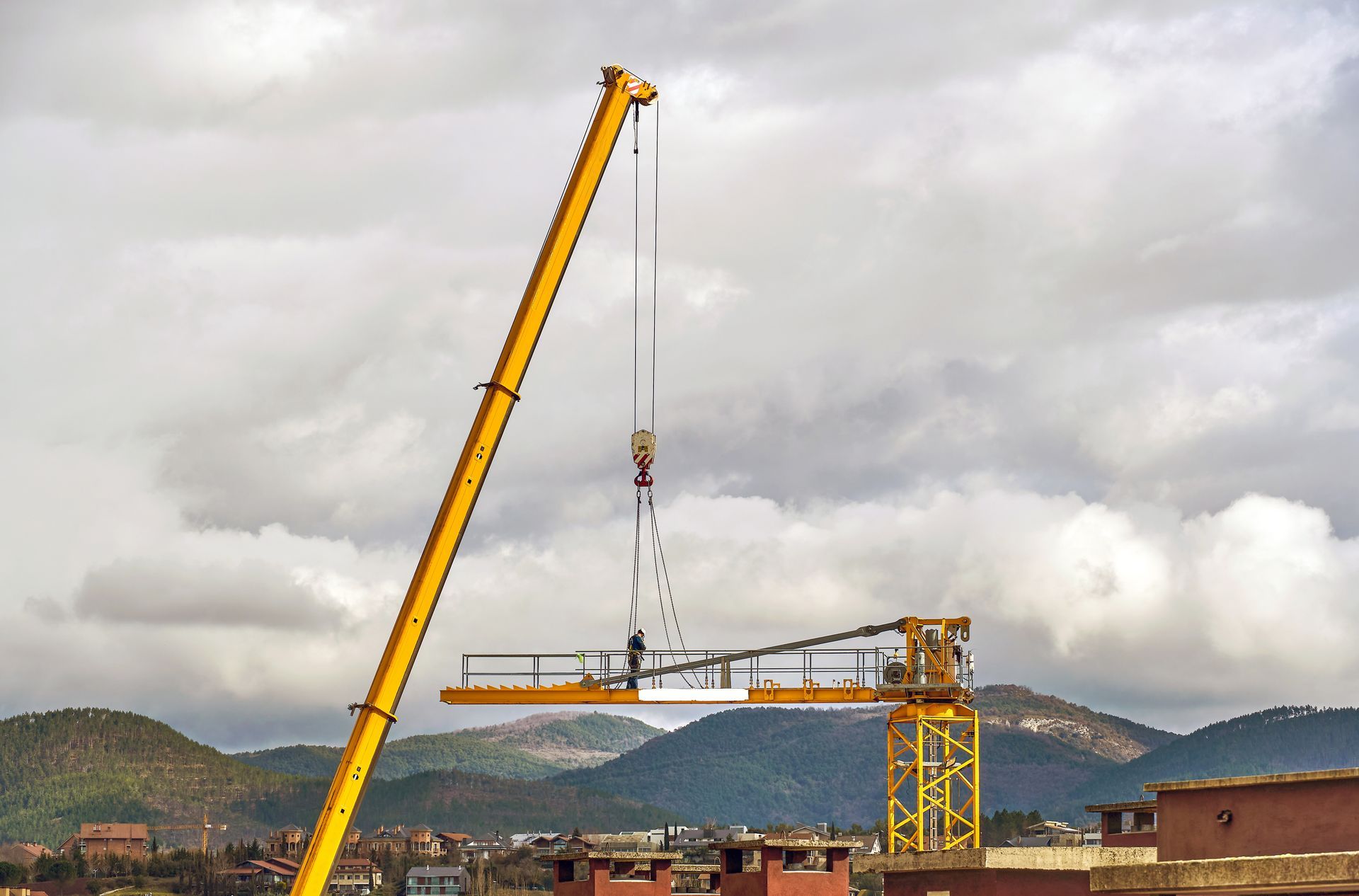 A crane lifts a large object in a construction site