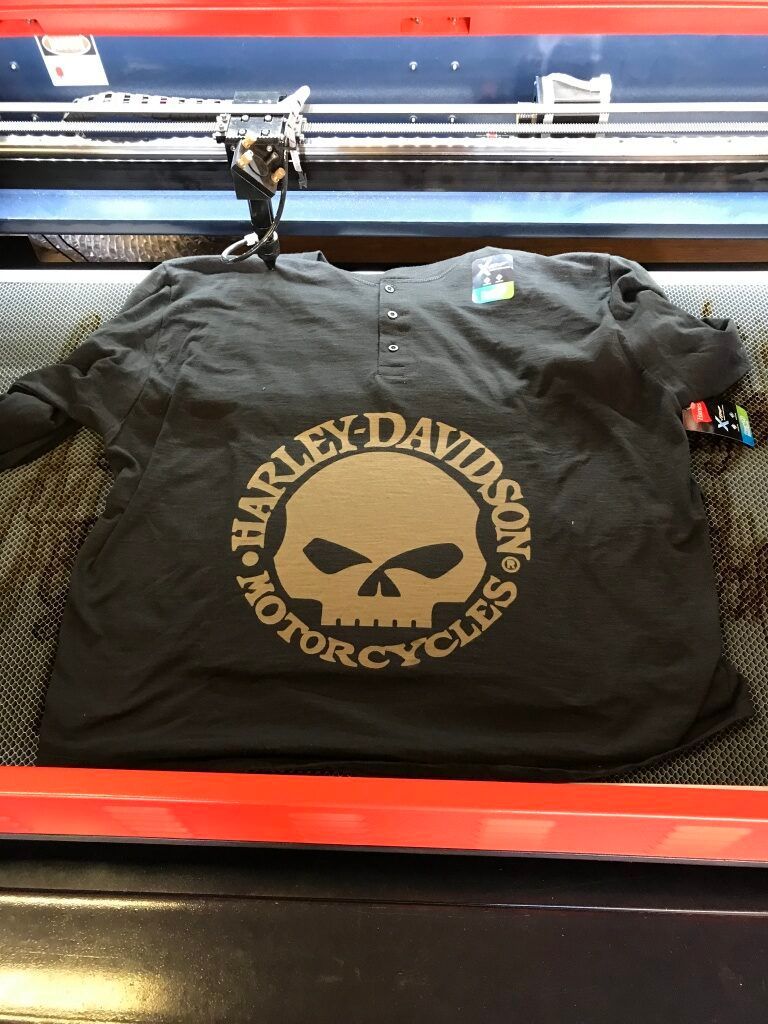 Black Harley-Davidson motorcycle club T-shirt with skull logo on a display rack