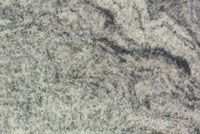 Close-up of light gray speckled granite with dark wavy veins