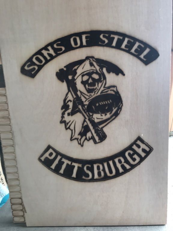 Pittsburgh Steelers “Sons of Steel” logo engraved on a light wooden plaque