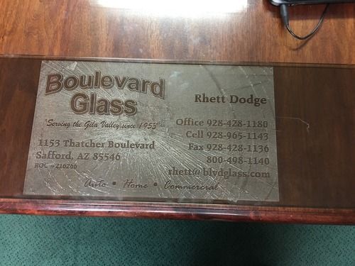 Business card for Boulevard Glass on a wooden table, with Rhct Dodge and contact details.