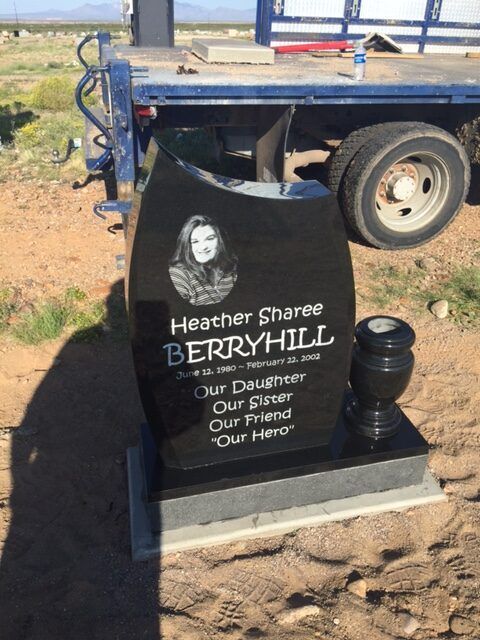 Memorial plaque on a trailer reads “Heather Sharpe BERRYHILL,” with a portrait and “Our Daughter, Our Friend, Our Hero.”