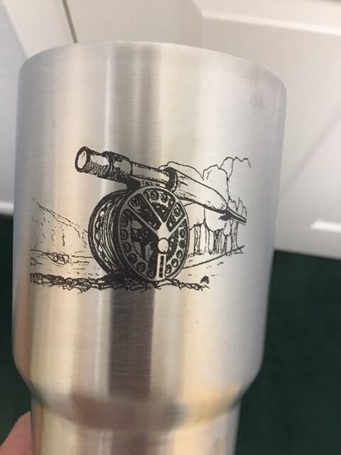 Silver tumbler with a black cannon and buildings illustration printed on it