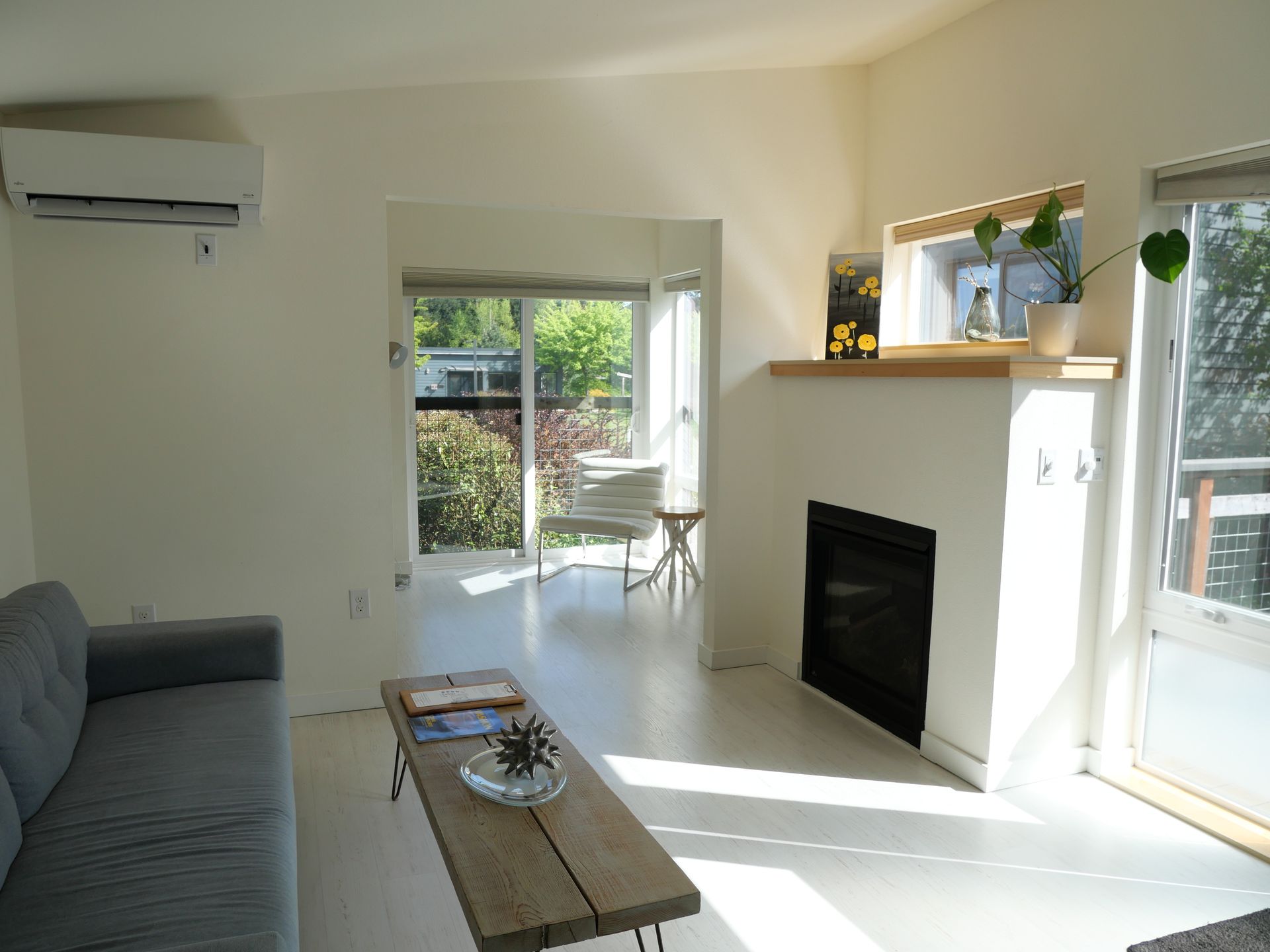 Courtyard Suite interior with king bed, twin sleeping nook, and wet bar on Vashon Island. Featured Fireplace. 